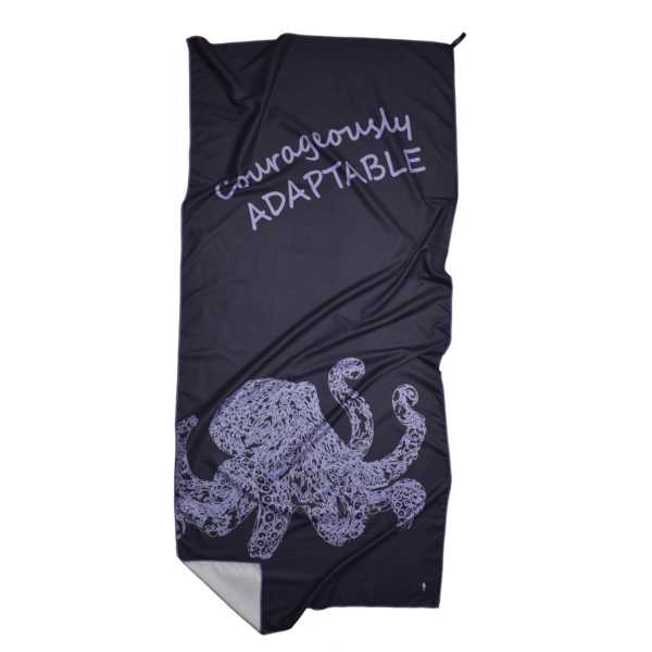 CANYLA XL Microfiber Beach Towel, purple, showing text "Courageously ADAPTABLE", and the drawing of an octopus. Bottom left corner is folded over.