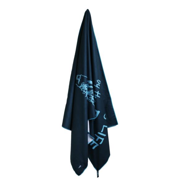 CANYLA XL Microfiber Beach Towel, hanging, blue, hinting at the text "Grabbing LIFE by the FIN", and the drawing of a humpback whale.